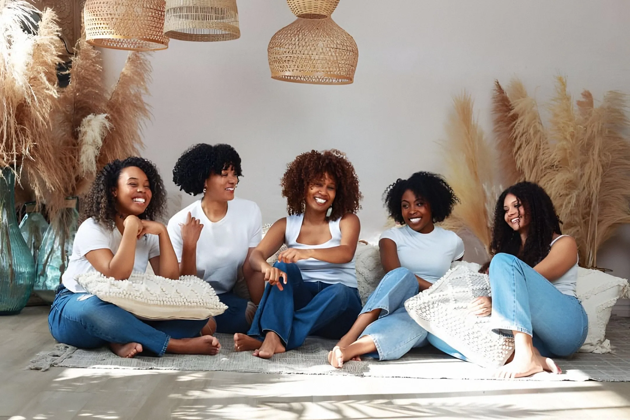 Hair type chart in real life: Bianca and five clients with curly and coily hair, sitting in jeans among pampas grass, Montreal studio
